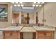 Bathroom features granite countertops, wooden cabinets, double sinks, decorative mirror and recessed lighting at 1665 W 113Th Ave, Denver, CO 80234
