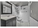 Renovated bathroom with sleek vanity, white tiling, and black-and-white mosaic flooring at 1665 W 113Th Ave, Denver, CO 80234