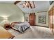 Bright bedroom with vaulted ceiling features a ceiling fan, skylight, and large windows for plenty of natural light at 1665 W 113Th Ave, Denver, CO 80234