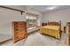 Bedroom features a neutral-toned color scheme, a large window, wood trim, and carpeted floors at 1665 W 113Th Ave, Denver, CO 80234