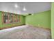 Green-painted bedroom featuring neutral carpeting, wood trim, and a large window with outside views at 1665 W 113Th Ave, Denver, CO 80234