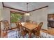 Charming dining room with a wooden table, six chairs and view of backyard at 1665 W 113Th Ave, Denver, CO 80234