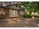 Charming home featuring mixed brick and siding, complemented by gravel landscaping and mature trees at dusk at 1665 W 113Th Ave, Denver, CO 80234