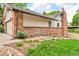 Well-maintained exterior featuring mixed brick and siding with a neatly landscaped yard and garden area at 1665 W 113Th Ave, Denver, CO 80234