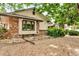 Charming home featuring mixed brick and siding, complemented by gravel landscaping and mature trees at 1665 W 113Th Ave, Denver, CO 80234
