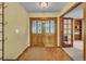 Inviting foyer featuring elegant double doors, hardwood floors, and seamless flow into adjacent living spaces at 1665 W 113Th Ave, Denver, CO 80234