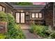 Inviting front entrance featuring elegant double doors, stone pathway, and beautifully landscaped surroundings at dusk at 1665 W 113Th Ave, Denver, CO 80234