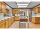 Open-concept kitchen with an island, stainless steel appliances, and abundant cabinet space at 1665 W 113Th Ave, Denver, CO 80234