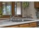 Close-up of kitchen sink with stainless steel hardware and window with backyard view at 1665 W 113Th Ave, Denver, CO 80234