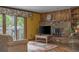 Inviting living room with fireplace, view of patio and natural light at 1665 W 113Th Ave, Denver, CO 80234