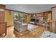 Cozy living room features wood paneling, fireplace, and access to a private patio at 1665 W 113Th Ave, Denver, CO 80234