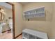 Mudroom features a bench with storage, hooks, and shelving, with a bathroom visible through an open doorway at 1665 W 113Th Ave, Denver, CO 80234