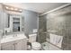 Modern bathroom featuring a glass-enclosed shower, vanity, and updated fixtures at 2562 E 90Th Pl, Thornton, CO 80229
