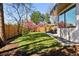Spacious backyard with a well-maintained lawn, a wooden fence, and an outdoor dining set on a concrete patio at 267 S Clermont St, Denver, CO 80246