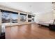 Bright primary bedroom with hardwood floors, fireplace, walkout balcony, and large windows with views at 267 S Clermont St, Denver, CO 80246