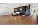 Modern bedroom features hardwood floors, a built-in bar, and a stylish accent wall with contemporary lighting at 267 S Clermont St, Denver, CO 80246