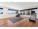 Bright home gym with hardwood floors, large windows offering city views, and exercise equipment for a healthy lifestyle at 267 S Clermont St, Denver, CO 80246