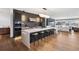 Open-concept kitchen featuring a large waterfall island, modern lighting, and stainless steel appliances at 267 S Clermont St, Denver, CO 80246