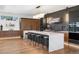 Spacious kitchen with a waterfall island, modern stools, hardwood floors, and sleek cabinets at 267 S Clermont St, Denver, CO 80246