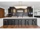 Gourmet kitchen featuring waterfall island with seating, stainless steel appliances, and custom lighting at 267 S Clermont St, Denver, CO 80246