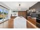 Open kitchen design boasts a large center island, stainless steel appliances, and sliding door access to patio at 267 S Clermont St, Denver, CO 80246