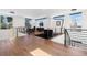 Spacious loft area with hardwood floors, large windows, black railings, and contemporary lighting fixtures at 267 S Clermont St, Denver, CO 80246