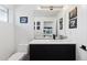 Chic powder room features modern vanity, white walls adorned with framed artwork at 267 S Clermont St, Denver, CO 80246