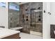 Luxurious shower features a glass enclosure, marble-look tiles, a built-in bench, and modern fixtures at 267 S Clermont St, Denver, CO 80246