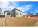 An exterior view of a home with a spacious backyard and blue skies at 9283 Biscay St, Commerce City, CO 80022