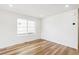 This bedroom boasts a large window and spacious area with light hardwood flooring at 9283 Biscay St, Commerce City, CO 80022