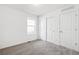 Bedroom featuring a large window, sliding door closet and a separate entrance at 9283 Biscay St, Commerce City, CO 80022