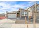 Charming home with a warm wood door, stone accents and attached garage at 9283 Biscay St, Commerce City, CO 80022