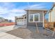 Exterior view of home with attached garage, stone accents, and xeriscaped yard at 9283 Biscay St, Commerce City, CO 80022