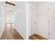Bright hallway with hardwood floors, white walls, and recessed lighting at 9283 Biscay St, Commerce City, CO 80022