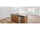 Kitchen area features an island with a sink and stainless steel appliances at 9283 Biscay St, Commerce City, CO 80022