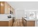 Modern kitchen featuring an island, stainless steel appliances, and light hardwood floors at 9283 Biscay St, Commerce City, CO 80022