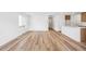 Bright living room featuring light hardwood floors and abundant natural light through a large window at 9283 Biscay St, Commerce City, CO 80022