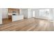 Bright living area with hardwood floors and a modern kitchen with a center island at 9283 Biscay St, Commerce City, CO 80022