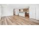 Open-concept living space with hardwood floors and a modern kitchen at 9283 Biscay St, Commerce City, CO 80022