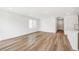 Bright living room featuring light hardwood floors and abundant natural light through a large window at 9283 Biscay St, Commerce City, CO 80022