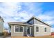 Back exterior view of home with gray siding and neatly landscaped backyard at 9283 Biscay St, Commerce City, CO 80022