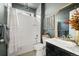 Cozy bathroom featuring a tiled shower-tub and elegant vanity with marble countertop at 840 Avena Dr, Elizabeth, CO 80107