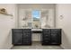 Dual-sink bathroom featuring granite counters, modern fixtures and stylish vanity at 840 Avena Dr, Elizabeth, CO 80107