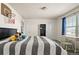 Bedroom featuring a striped bedcover, basketball hoop, neutral walls, and bright natural light at 840 Avena Dr, Elizabeth, CO 80107