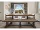 Dining area features a large wood table, bench seating, lots of light, and modern decorative touches at 840 Avena Dr, Elizabeth, CO 80107