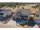 Aerial view of gray two-story home featuring a front porch and three-car garage at 840 Avena Dr, Elizabeth, CO 80107