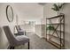 Hallway featuring sitting area with two decorative chairs, accent table, and views of the staircase and main floor at 840 Avena Dr, Elizabeth, CO 80107
