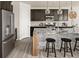 This kitchen boasts modern stainless steel appliances, granite countertops, dark cabinets, and stylish barstool seating at 840 Avena Dr, Elizabeth, CO 80107