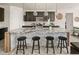 Modern kitchen with stone-clad island, granite countertops, pendant lighting, and bar stool seating at 840 Avena Dr, Elizabeth, CO 80107