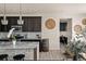 This kitchen has sleek dark cabinets, granite countertops, stainless appliances, and stylish modern pendant lights at 840 Avena Dr, Elizabeth, CO 80107